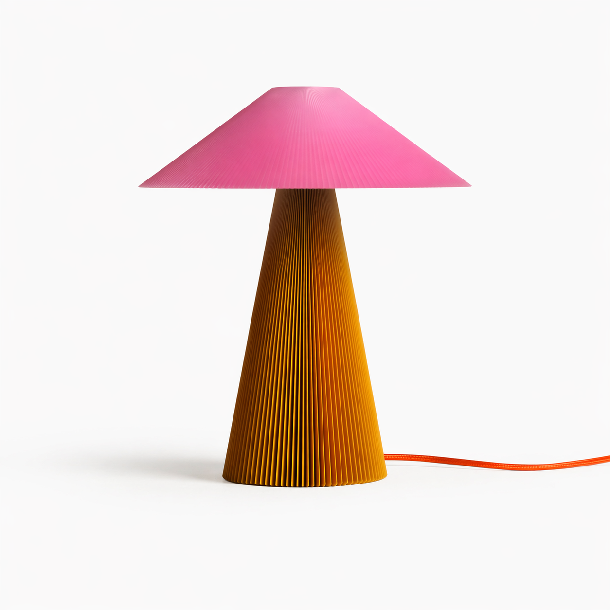 The Jane Teen table lamp by Manu Matters in a pink and mustard color mix. A 3D-printed lamp made from recycled plastic featuring a vibrant ribbed surface.