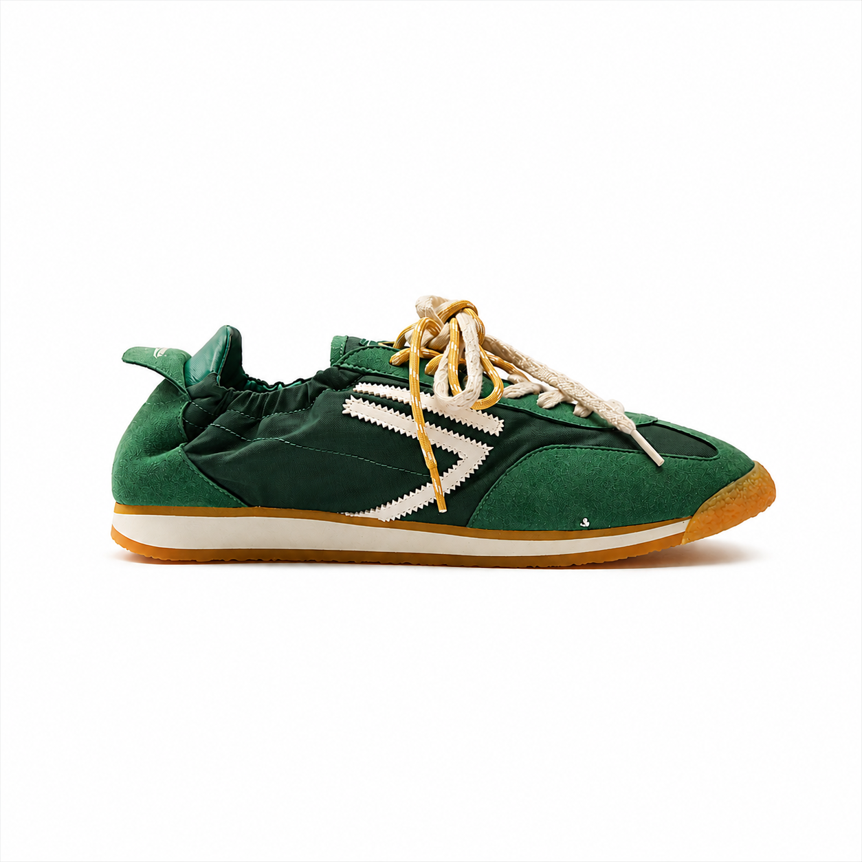 Green vegan football sneakers by Puraai, crafted from recycled nylon and microsuede in Marche, Italy. Featuring a vintage athletic silhouette and yellow double laces for a refined lifestyle look.