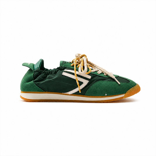 Green vegan football sneakers by Puraai, crafted from recycled nylon and microsuede in Marche, Italy. Featuring a vintage athletic silhouette and yellow double laces for a refined lifestyle look.