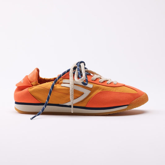 Orange vegan sneakers by Puraai, crafted from recycled nylon and microsuede in Marche, Italy. Featuring a vintage athletic silhouette with blue and beige double laces for a refined lifestyle look.